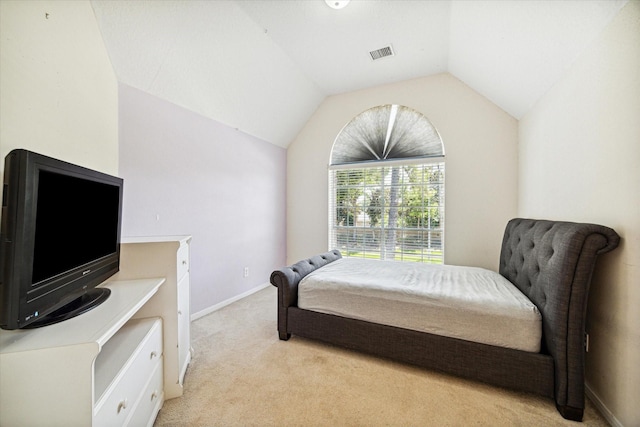 bedroom featuring light carpet and vaulted ceiling