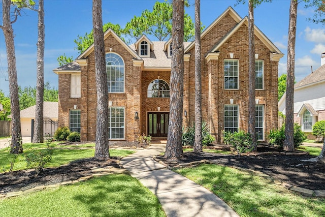 view of front of property with a front lawn and french doors