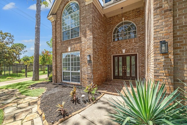 view of exterior entry featuring french doors