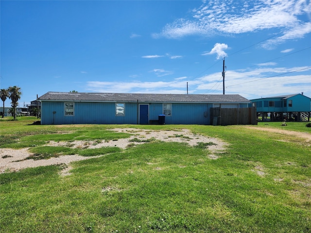 back of house with a lawn