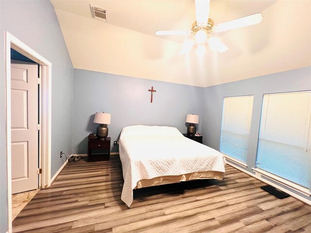 bedroom featuring wood-type flooring, ceiling fan, and lofted ceiling