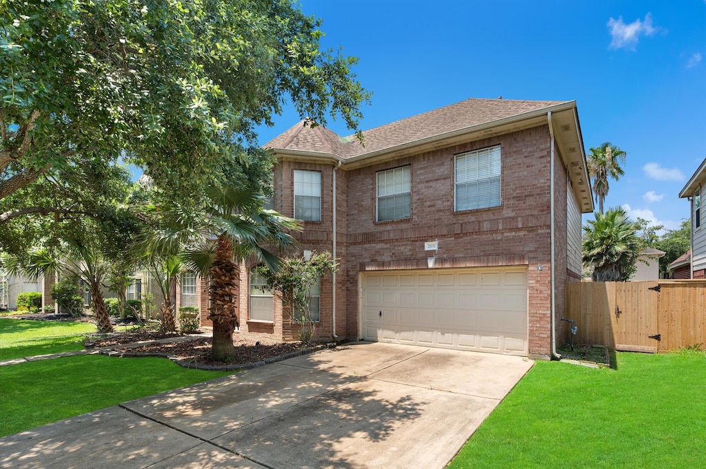 view of front of property featuring a garage and a front lawn