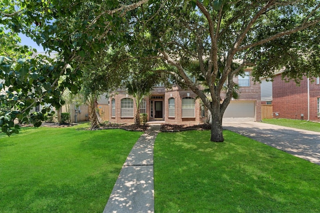 view of property hidden behind natural elements featuring a front yard and a garage