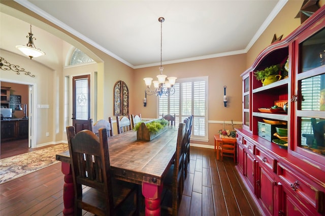 dining space with an inviting chandelier, crown molding, baseboards, and dark wood-type flooring