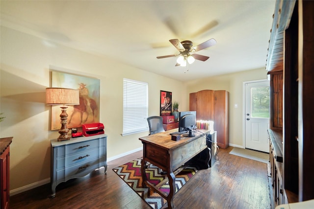 office area with dark wood finished floors, baseboards, and ceiling fan