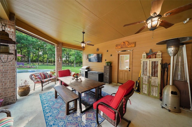 view of patio / terrace featuring a ceiling fan, outdoor dining space, an outdoor pool, and area for grilling