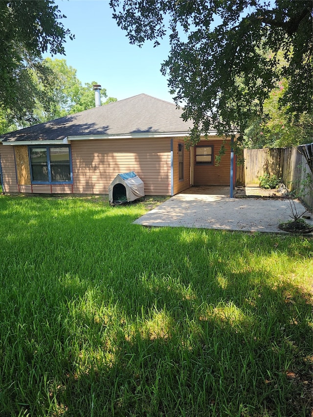 back of house with a lawn and a patio area