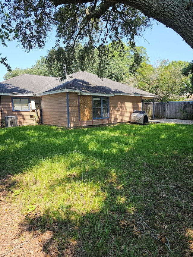 back of property featuring a yard