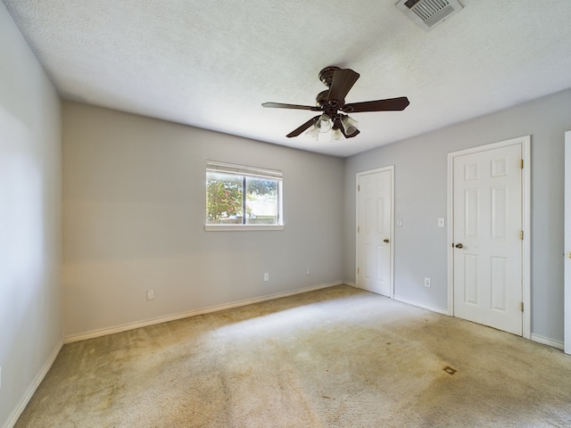 unfurnished bedroom with ceiling fan and light colored carpet