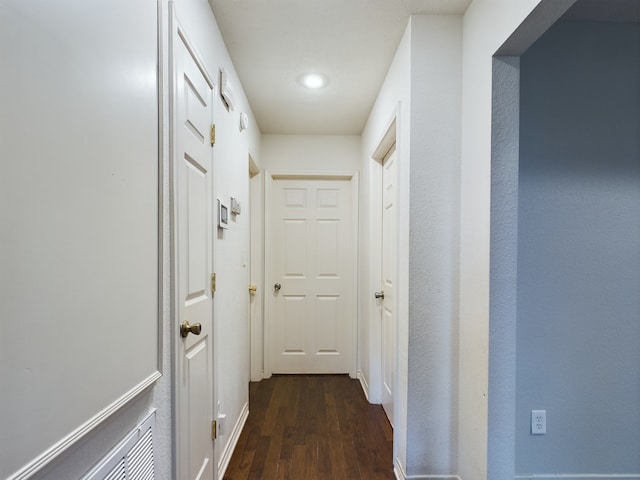 hallway featuring dark wood-type flooring