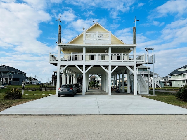 raised beach house featuring a carport