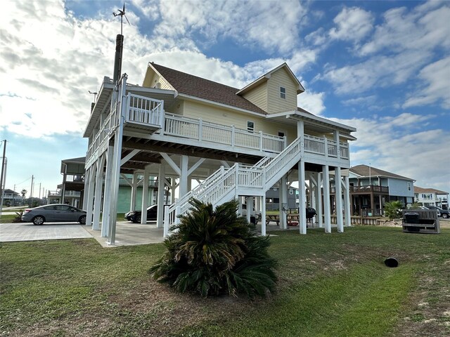 rear view of property featuring a yard and a carport