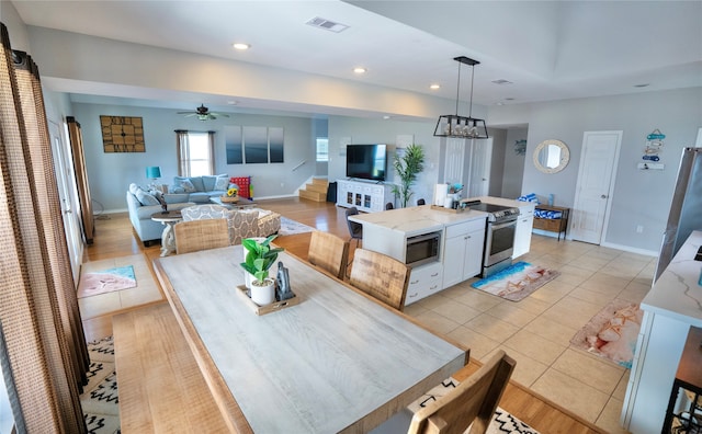 tiled dining area featuring ceiling fan