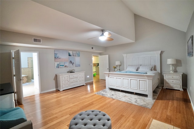 bedroom with high vaulted ceiling, ceiling fan, connected bathroom, and hardwood / wood-style flooring