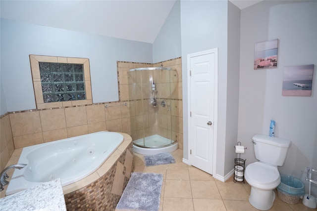 bathroom featuring tile floors, vaulted ceiling, toilet, and independent shower and bath