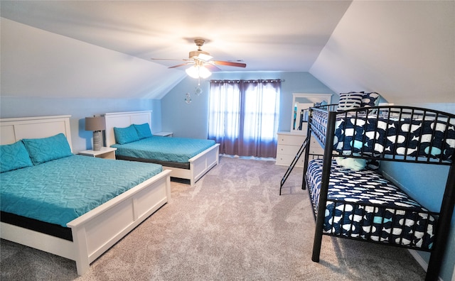 carpeted bedroom with vaulted ceiling and ceiling fan