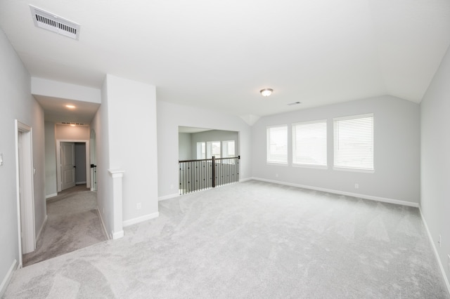 interior space with light carpet and lofted ceiling