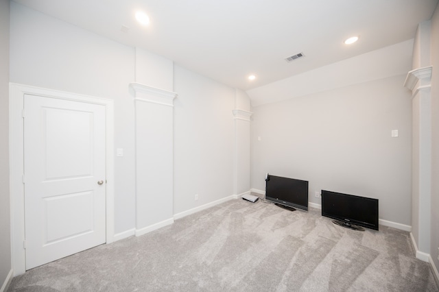 unfurnished room with vaulted ceiling and light colored carpet