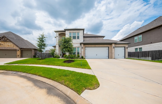 view of front of house featuring a front lawn and a garage