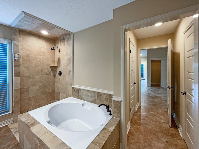 bathroom with shower with separate bathtub