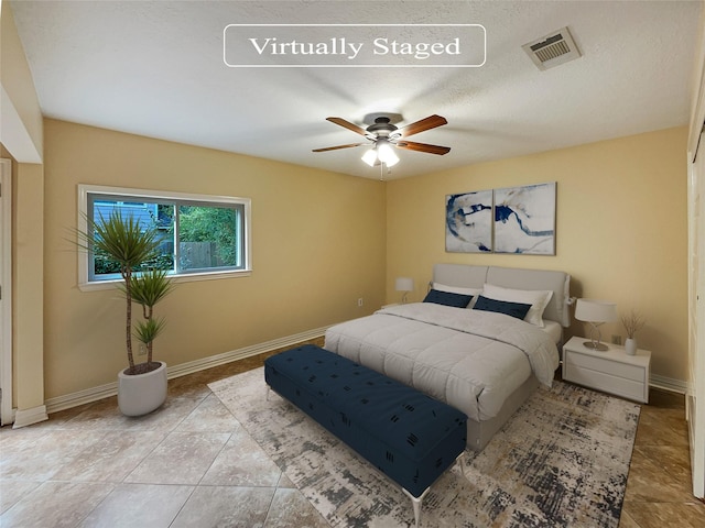 bedroom with ceiling fan and light tile patterned floors