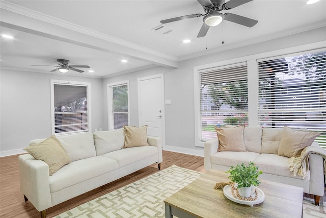 living room with hardwood / wood-style flooring, crown molding, and ceiling fan