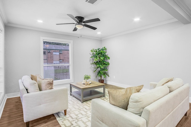 living room featuring ceiling fan, wood-type flooring, and ornamental molding