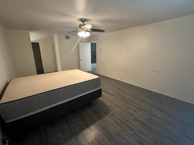 bedroom with ceiling fan and dark wood-type flooring