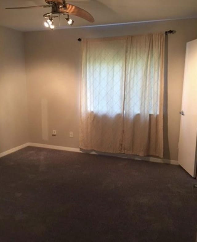 carpeted empty room featuring ceiling fan and a healthy amount of sunlight