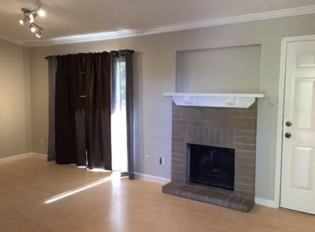 unfurnished living room featuring crown molding and light hardwood / wood-style floors