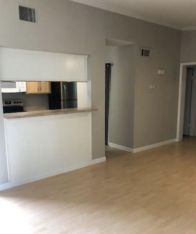 unfurnished living room with light hardwood / wood-style floors