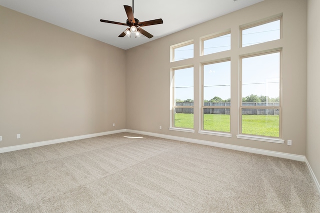 carpeted empty room featuring ceiling fan