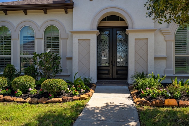 view of exterior entry featuring french doors