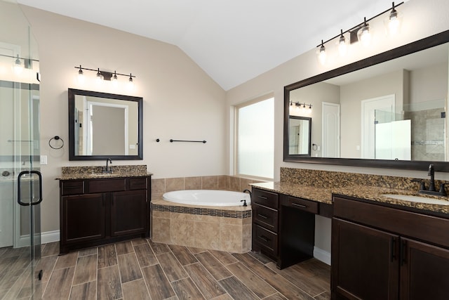 bathroom featuring vanity, lofted ceiling, and plus walk in shower