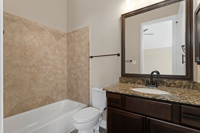 full bathroom with vanity, toilet, and tiled shower / bath combo