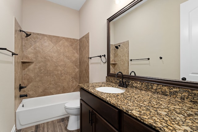 full bathroom with toilet, hardwood / wood-style floors, vanity, and tiled shower / bath