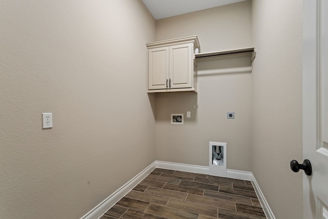 laundry room featuring hookup for an electric dryer, hookup for a washing machine, dark hardwood / wood-style flooring, cabinets, and gas dryer hookup