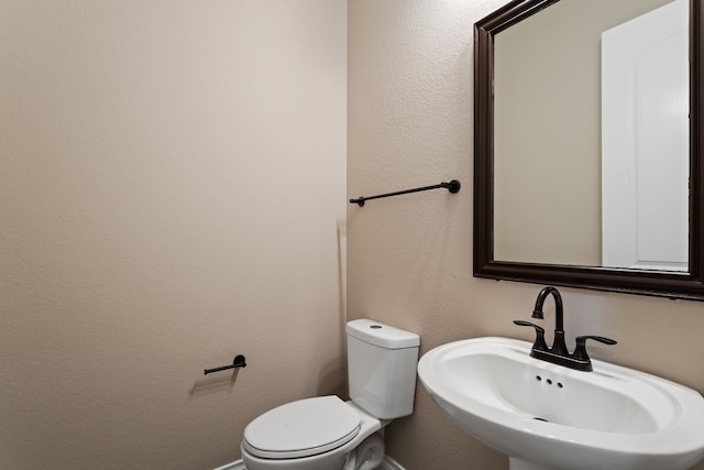 bathroom with toilet and sink