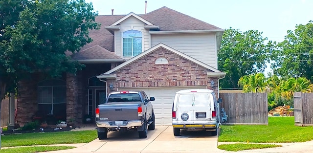 view of front of home with a front yard and a garage