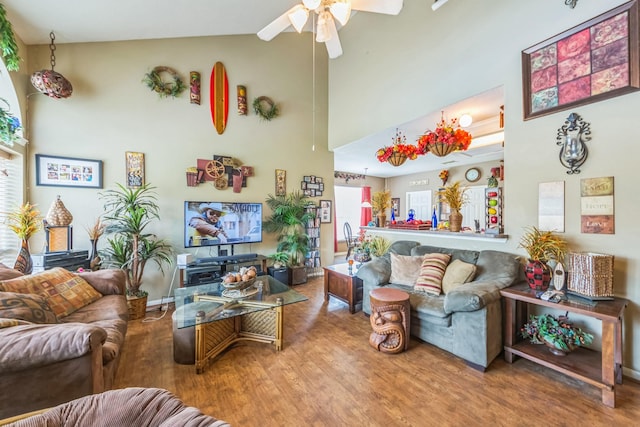 living room featuring hardwood / wood-style flooring, ceiling fan, and high vaulted ceiling