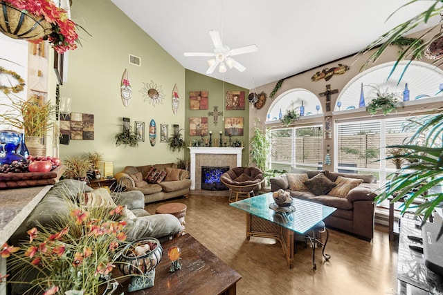 living room featuring ceiling fan, high vaulted ceiling, and wood-type flooring