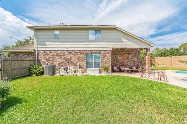 back of property featuring a yard, a patio, an outdoor hangout area, and central air condition unit