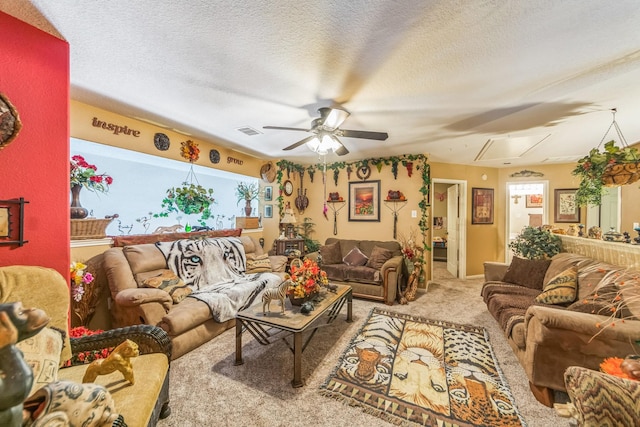 living room with ceiling fan, carpet floors, and a textured ceiling