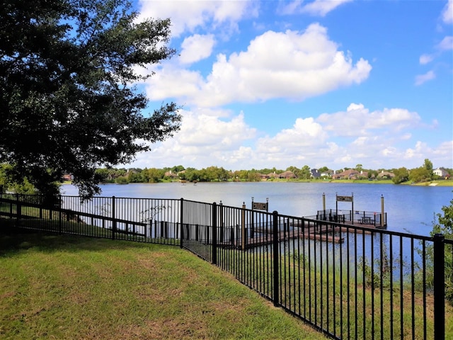 dock area featuring a lawn and a water view