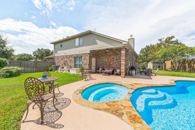 view of swimming pool with a patio area, an in ground hot tub, a yard, and central AC unit