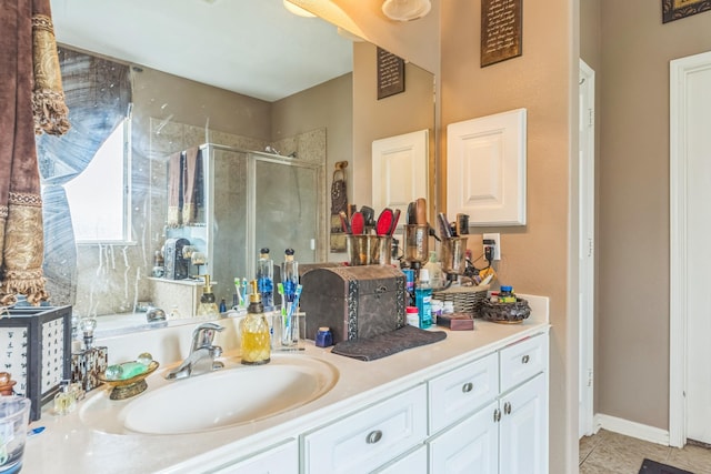 bathroom with tile patterned floors, vanity, and a shower with shower door