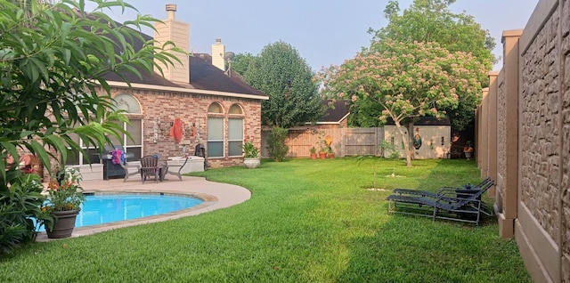 view of yard featuring a patio area and a fenced in pool