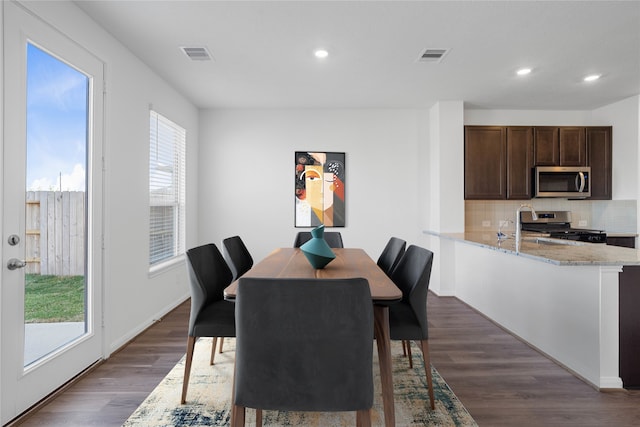 dining room with dark wood-type flooring