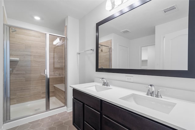 bathroom featuring walk in shower, vanity, and tile patterned floors