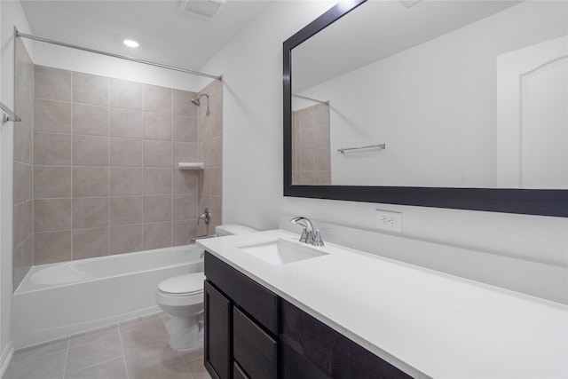 full bathroom with toilet, vanity, tiled shower / bath, and tile patterned floors